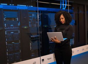 A woman using a laptop in a data center
