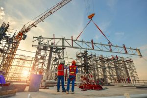 Two men wearing hard hats on a construction site